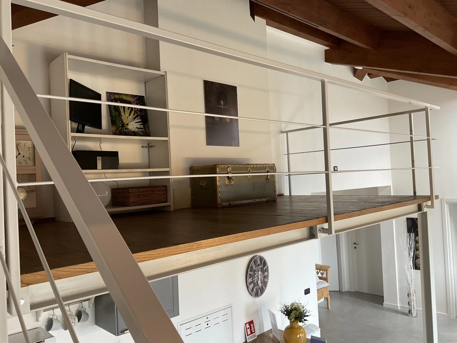 Detail of the mezzanine, bookcase and exposed beams